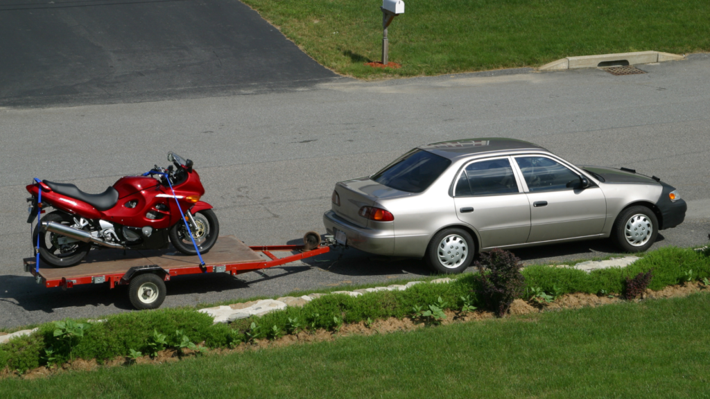 car towing the red bike